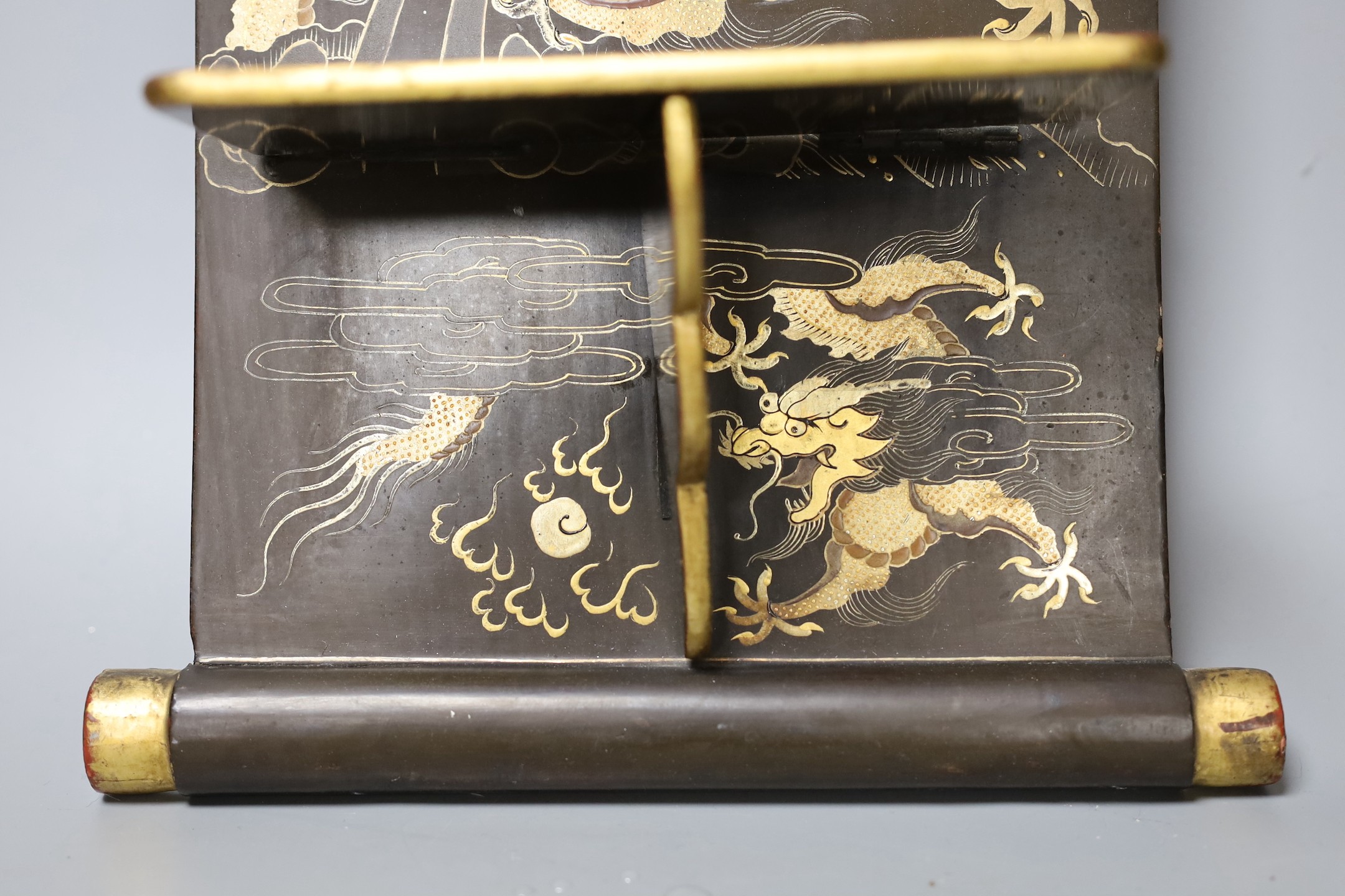 A Chinese lacquer ‘dragon’ wall shelf, 55x25cm